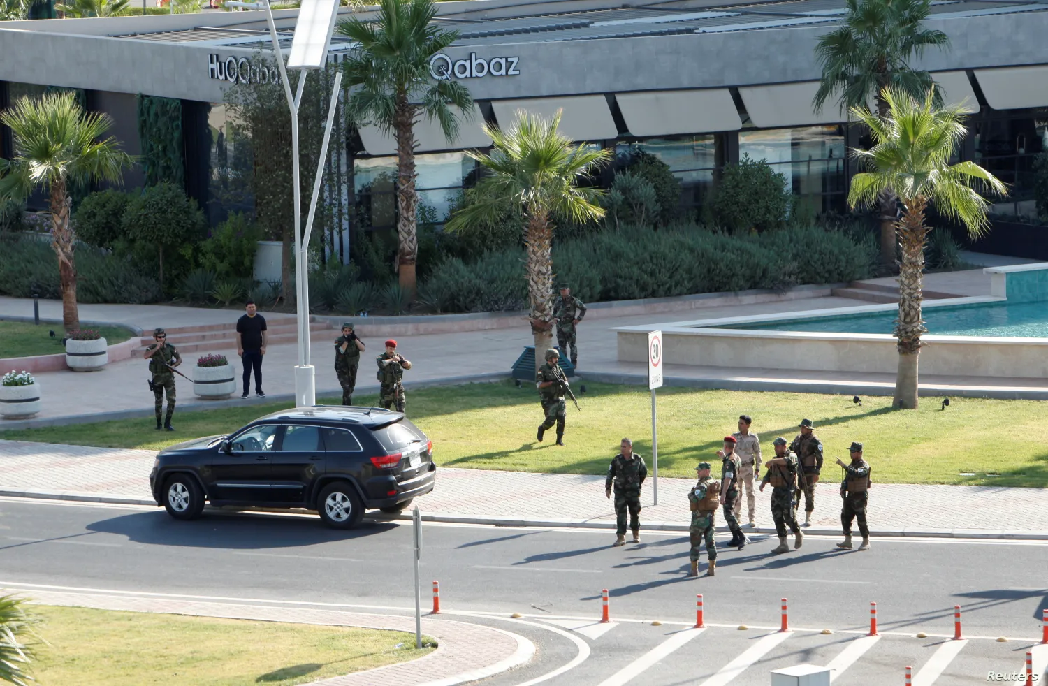  Kurdish security members gather near a restaurant where a gunman opened fire in Irbil, Iraq, July 17, 2019.
