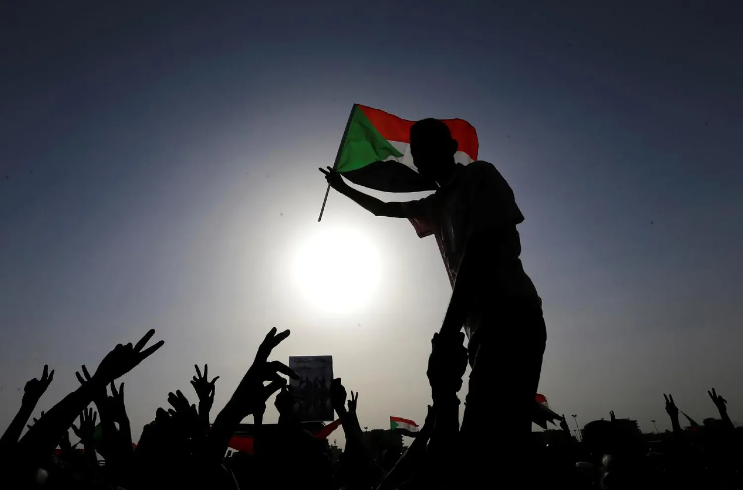 Protesters wave flags during a rally honoring fallen protesters at the Green Square in Khartoum, Sudan July 18, 2019. (Reuters)
