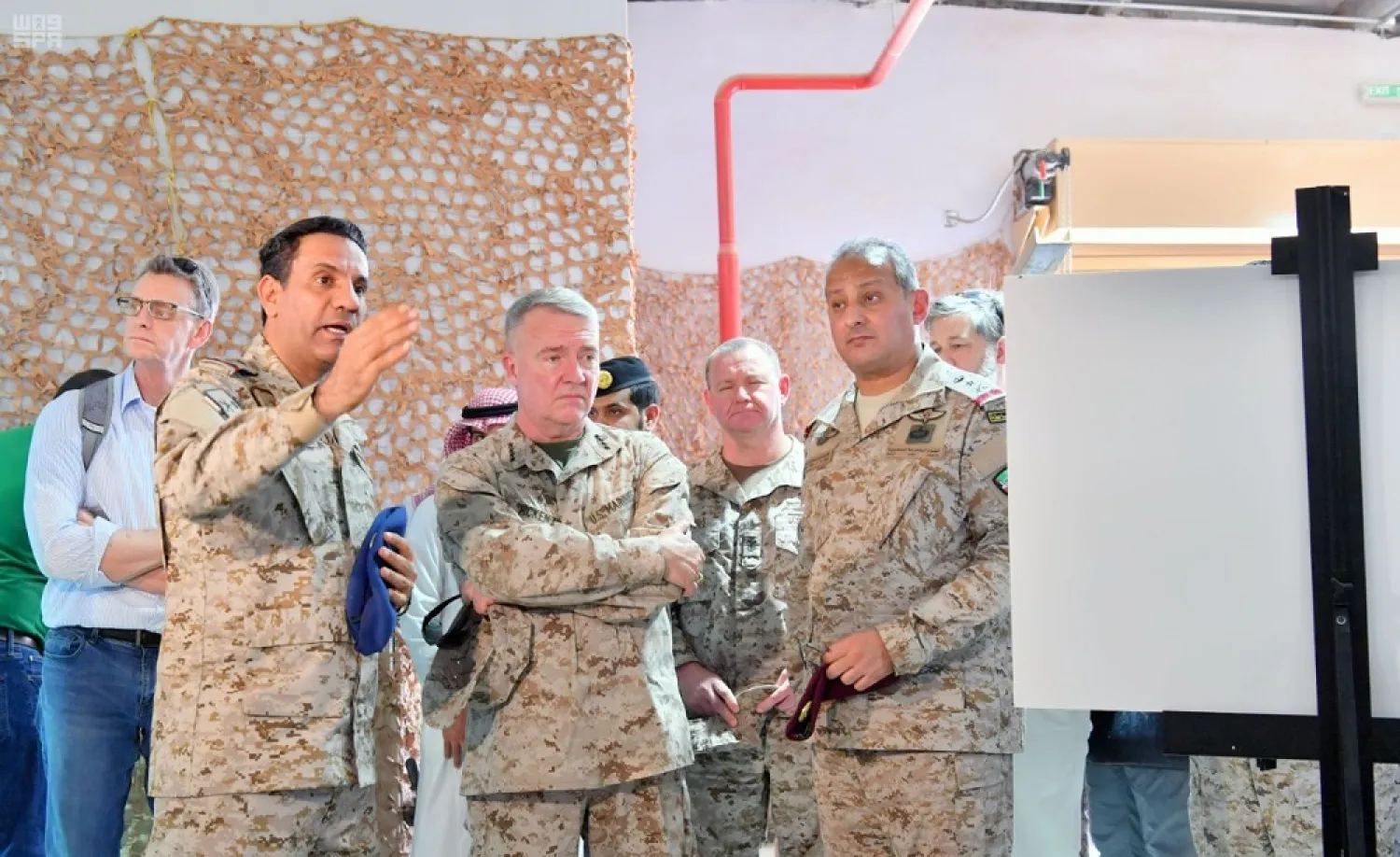 US Central Command chief Kenneth McKenzie tours of an exhibit displaying missiles and drones produced by Iran and used in the Houthi attacks. (SPA)