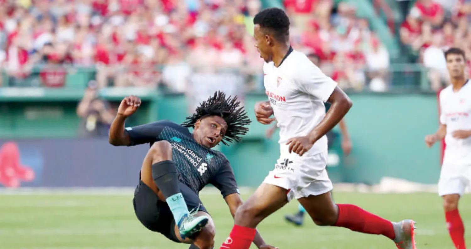 غنانيون لاعب إشبيلية (يمين) يصطدم بياسر العروسي لاعب ليفربول في لقطة أزعجت المدرب كلوب (أ.ف.ب)