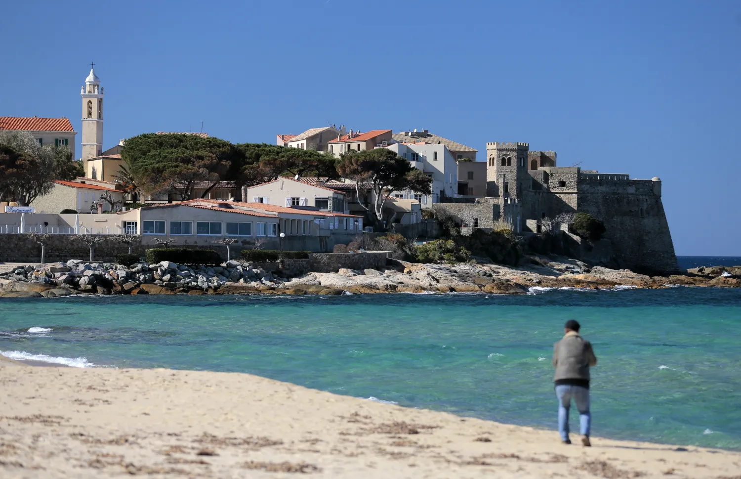 A man walks on the beach of Algajola on Feb. 18, 2017, on the French Mediterranean island of Corsica. AFP file photo