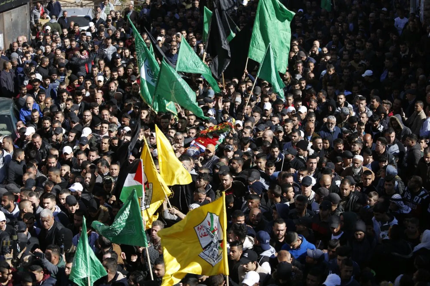 In this December 15, 2018 file photo, Palestinians carry the body of Mahmoud Nakhleh, who was killed by Israeli forces, during his funeral in the Jalazon refugee camp, near Ramallah. (AP)