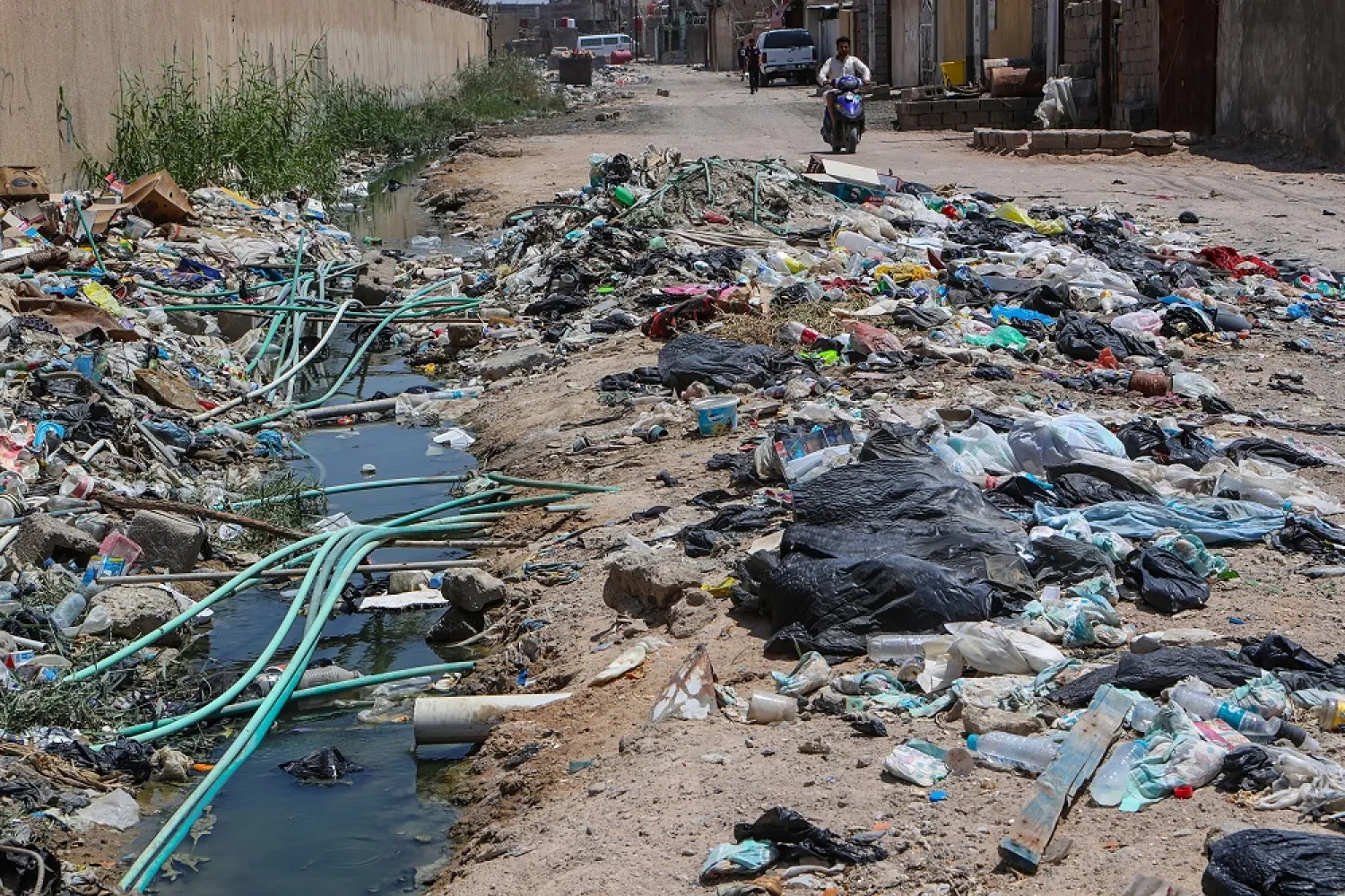 In this July, 20, 2019 photo, potable water pipes mix with sewage at a garbage dump in Basra, southeast of Baghdad, Iraq. (AP)