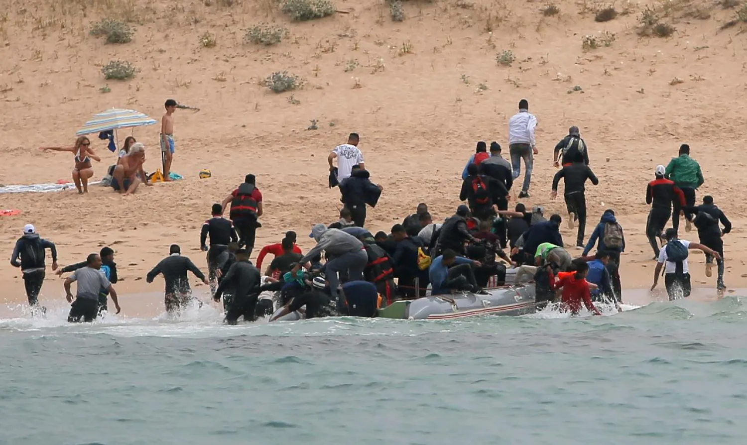 Migrants disembark from a dinghy at "Del Canuelo" beach after they crossed the Strait of Gibraltar sailing from the coast of Morocco. Reuters file photo