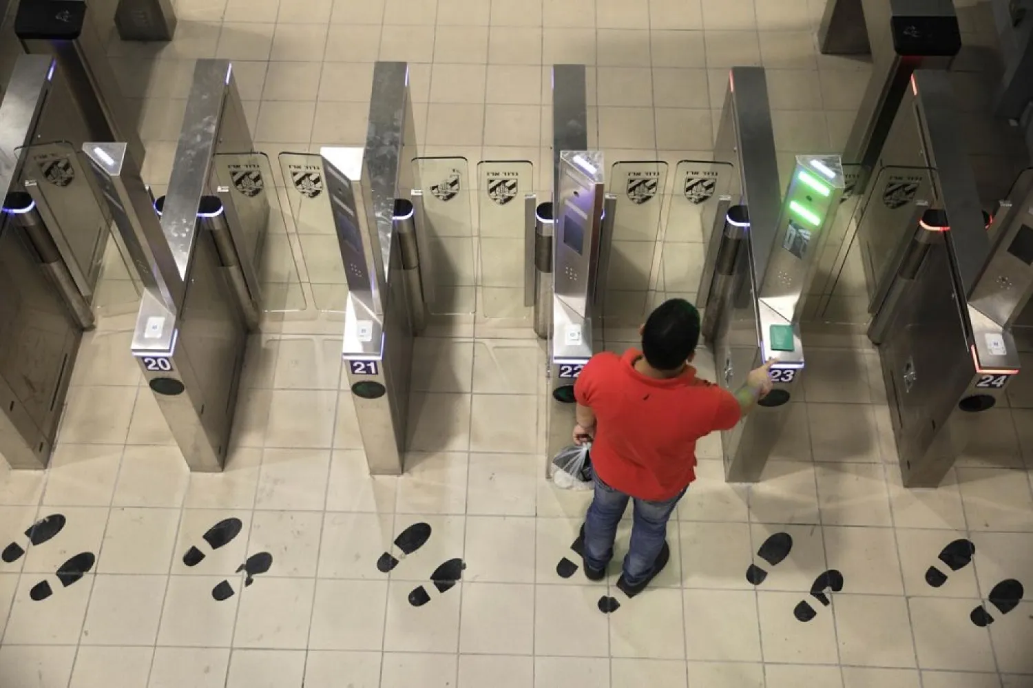 In this Thursday, July 11, 2019 photo, a Palestinian man uses a biometric gate as he crosses into Israel at the Qalandia crossing in Jerusalem. (AP)