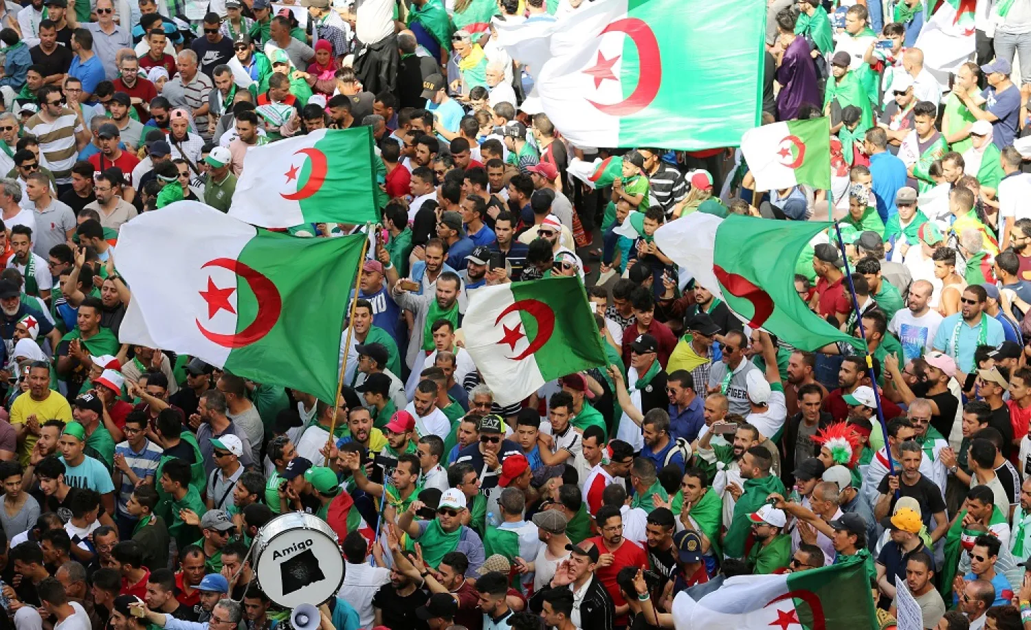 Demonstrators gesture and carry flags during a protest demanding the removal of the ruling elite in Algiers, Algeria, June 14, 2019. (Reuters)