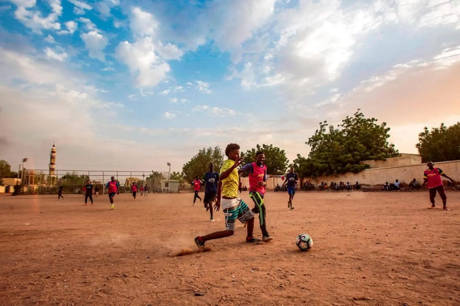 Sudanese youths play football on a dirt field in the capital Khartoum on July 28, 2019. (AFP)