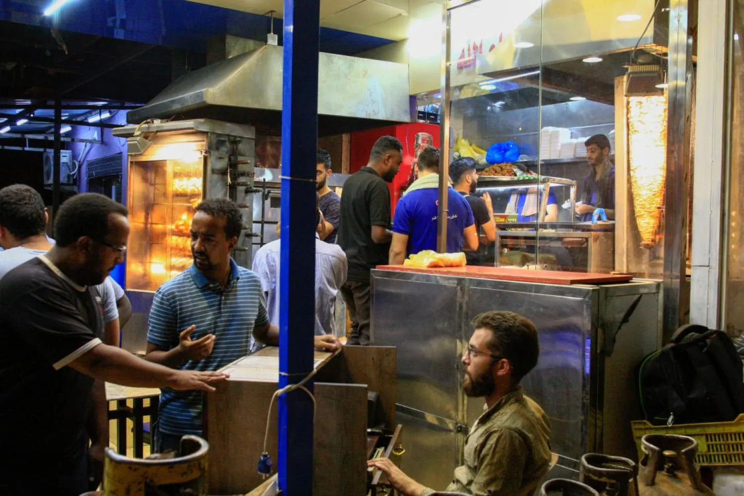 Customers wait for their sandwiches at a Syrian restaurant in the Kafouri neighborhood of the Sudanese capital Khartoum, on July 31, 2019. Ebrahim HAMID / AFP