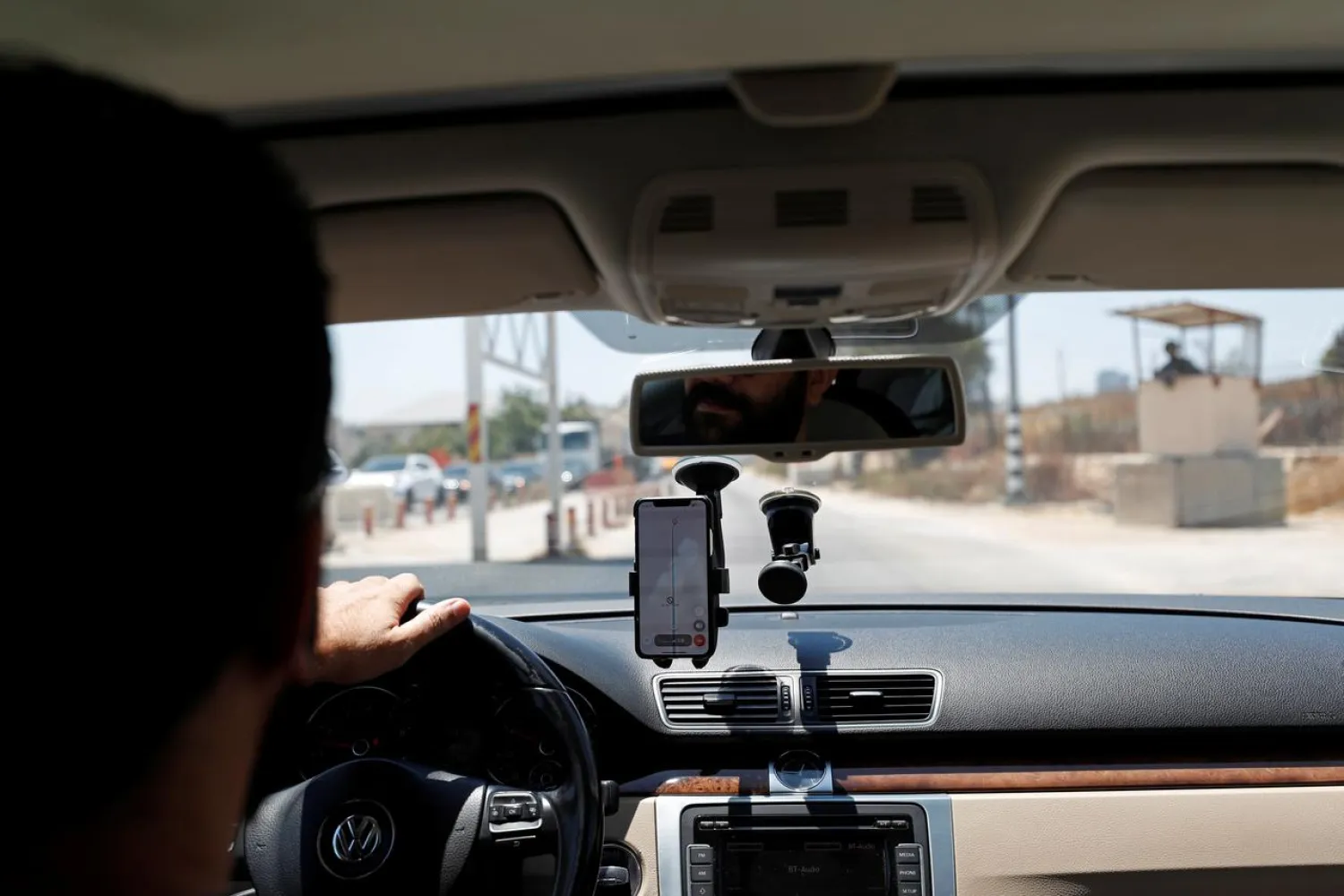 Mohammad Abdel Haleem, Chief Executive Officer of Doroob Technologies, uses Doroob Navigator application as he drives his car at an Israeli checkpoint in Ramallah, in the Israeli-occupied West Bank July 31, 2019. REUTERS/Mohamad Torokman
