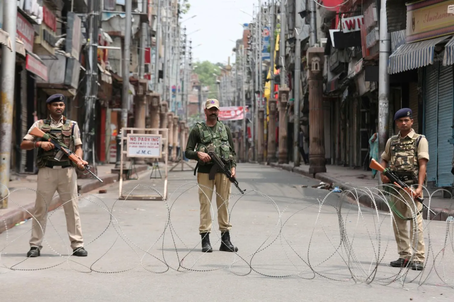 Indian security personnel stand guard along a deserted street during restrictions in Jammu, August 5, 2019. (Reuters)