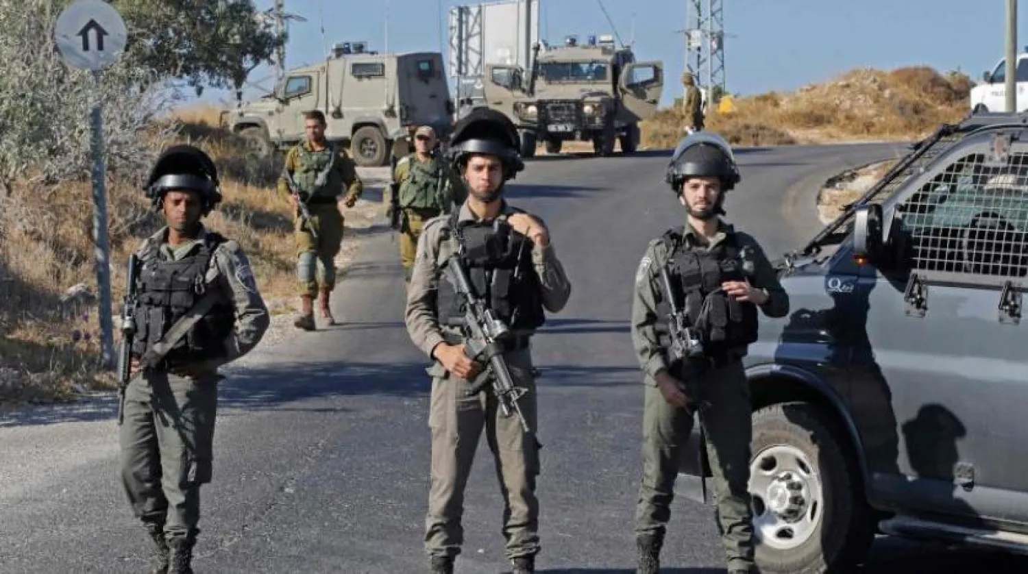 Israeli soldiers stand guard next to the site where the body of an Israeli soldier was found with multiple stabs near the settlement of Migdal Oz in the occupied West Bank on August 8, 2019. Hazem BADER / AFP