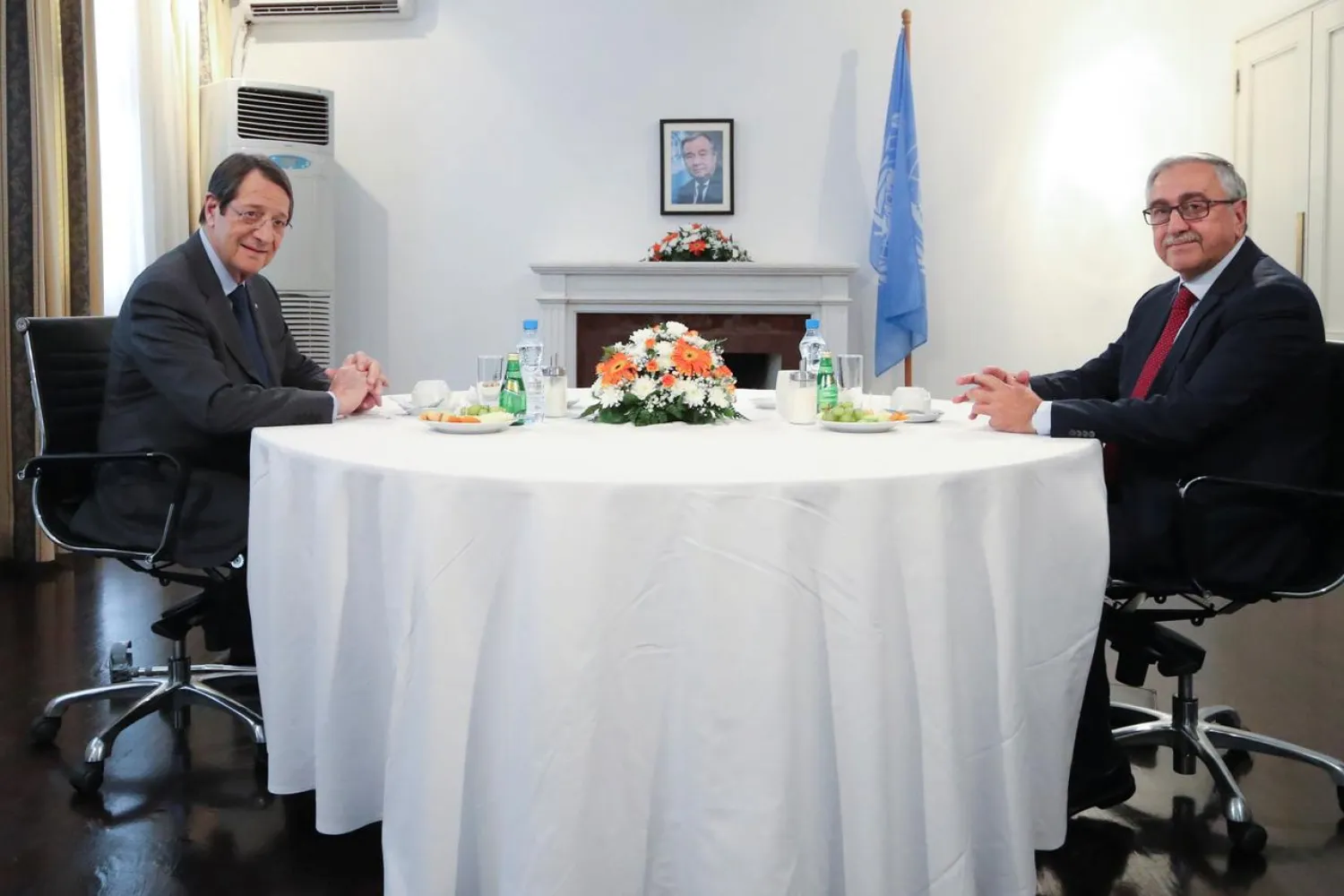 Cypriot leader Nicos Anastasiades and Turkish Cypriot leader Mustafa Akinci meet at the buffer zone of Nicosia airport. (Reuters)