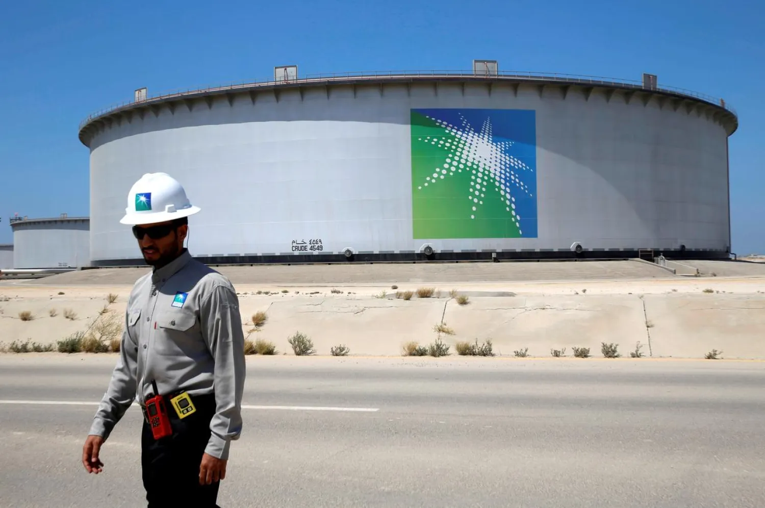 An Aramco employee walks near an oil tank at Saudi Aramco's Ras Tanura oil refinery and oil terminal in Saudi Arabia on May 21, 2018. Reuters/Ahmed Jadallah/File Photo