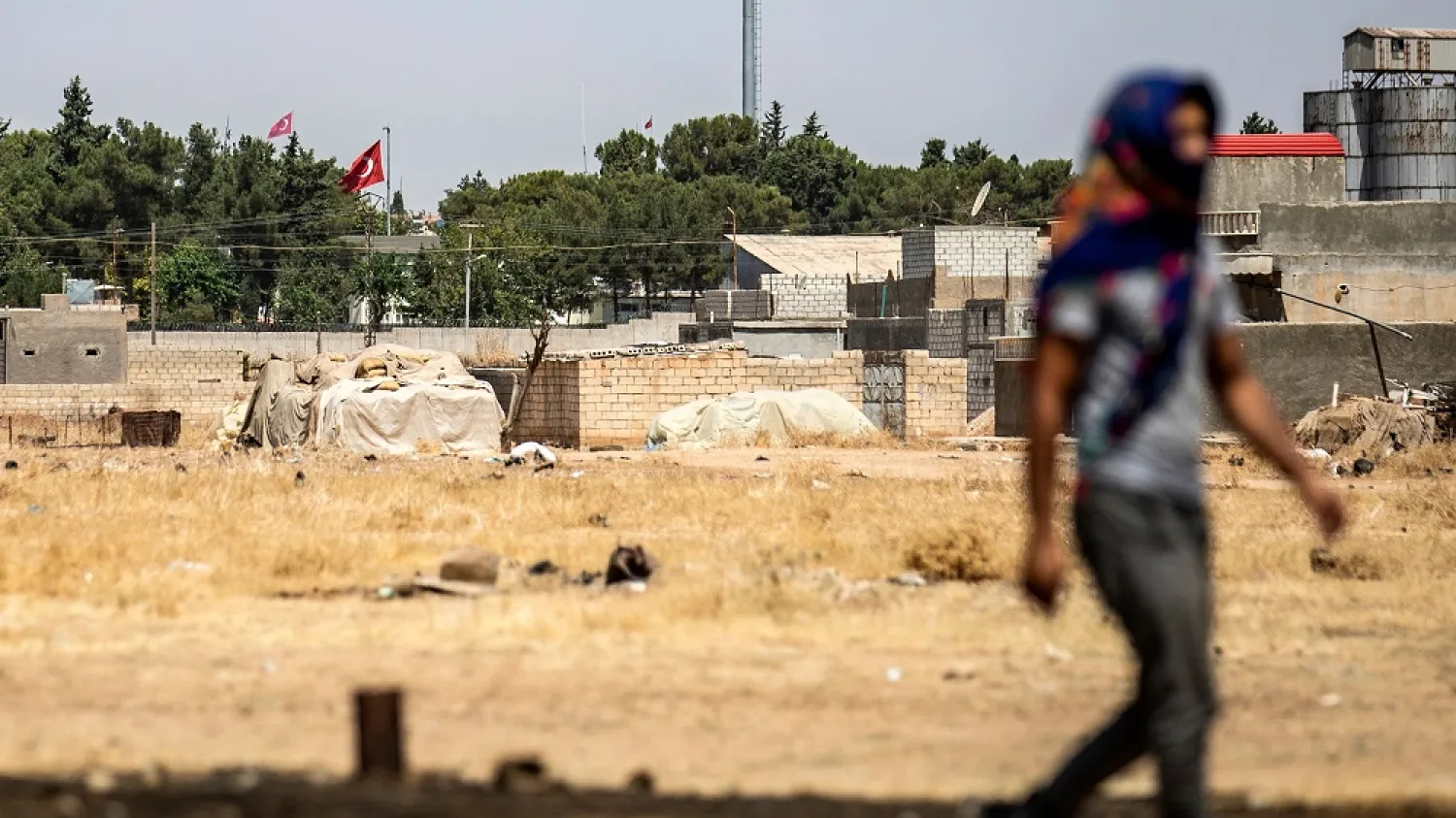 A Syrian Kurd walks during a protest and sit-in against Turkey, in the town of Ras al-Ain in Syria's Hasakeh province near the Turkish border, August 9, 2019. (Getty Images)
