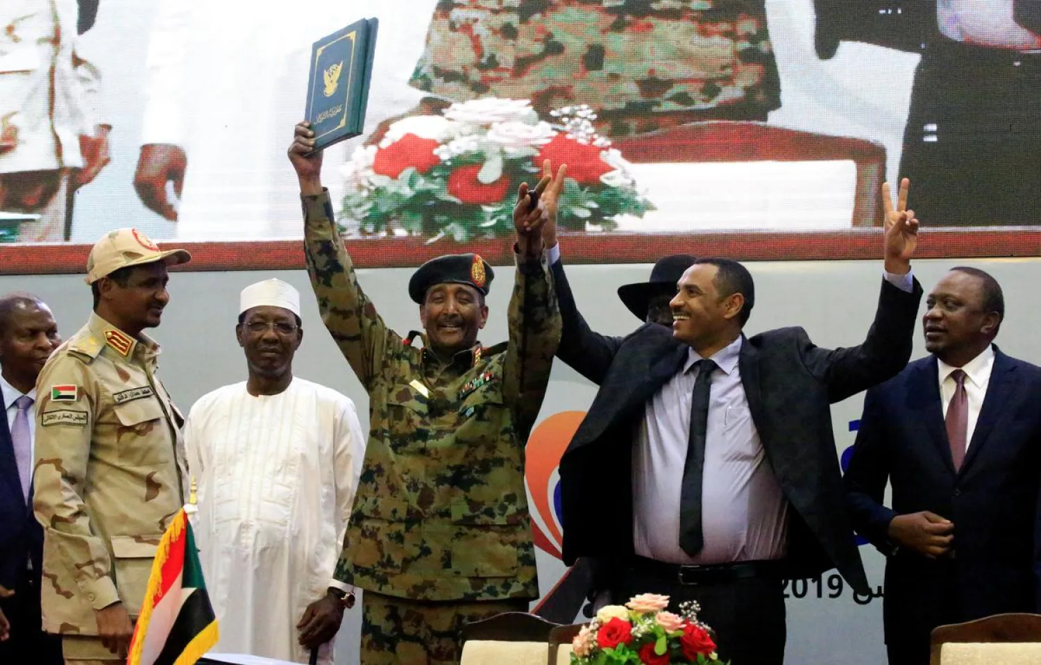 Lieutenant General Abdel Fattah Al-Burhan, and Sudan's opposition alliance coalition's leader Ahmad al-Rabiah, celebrate the signing of the power-sharing deal. REUTERS/Mohamed Nureldin Abdallah