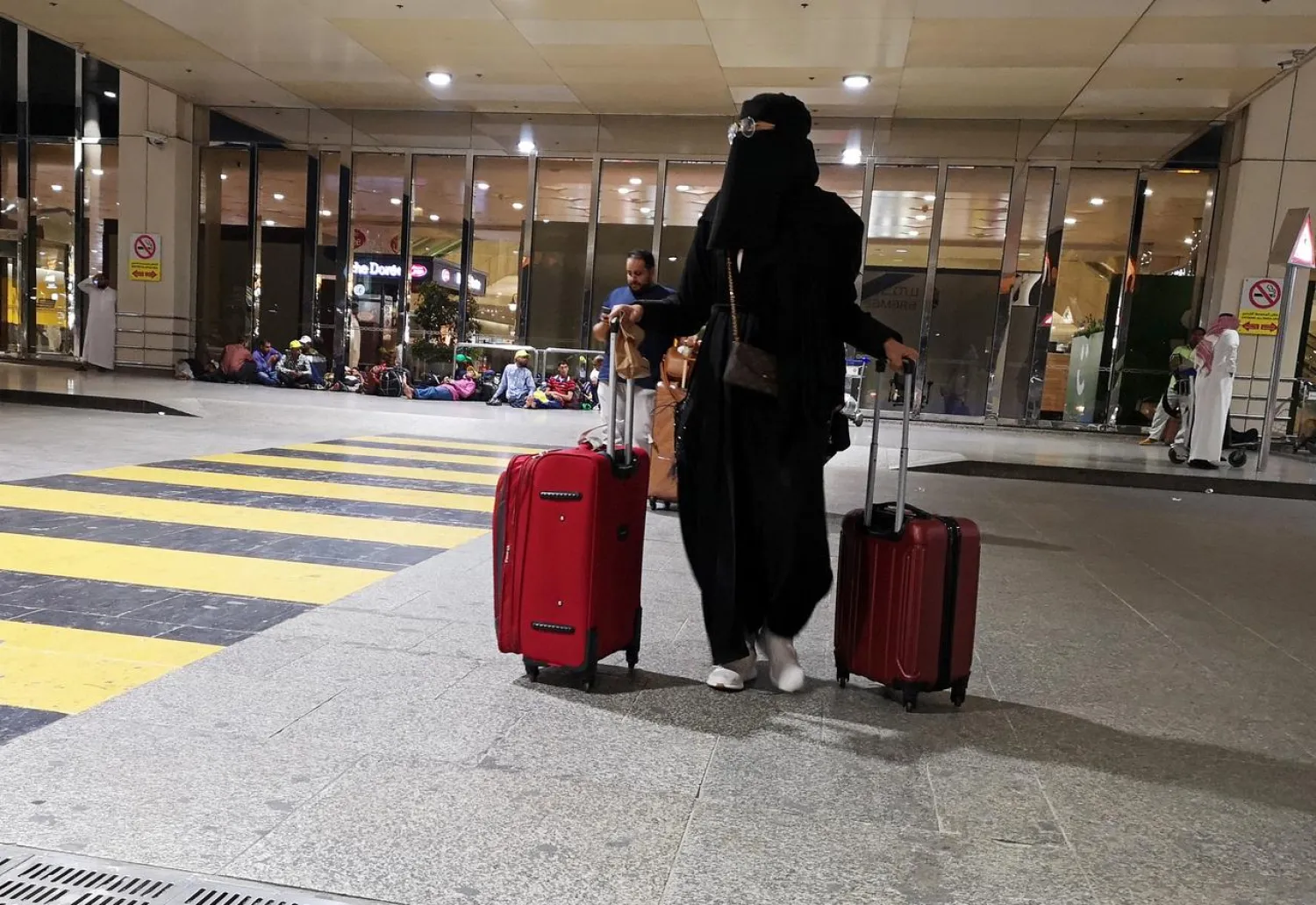 A Saudi woman walks with her luggage as she arrives at King Fahd International Airport in Dammam, Saudi Arabia, August 5, 2019. (Reuters)