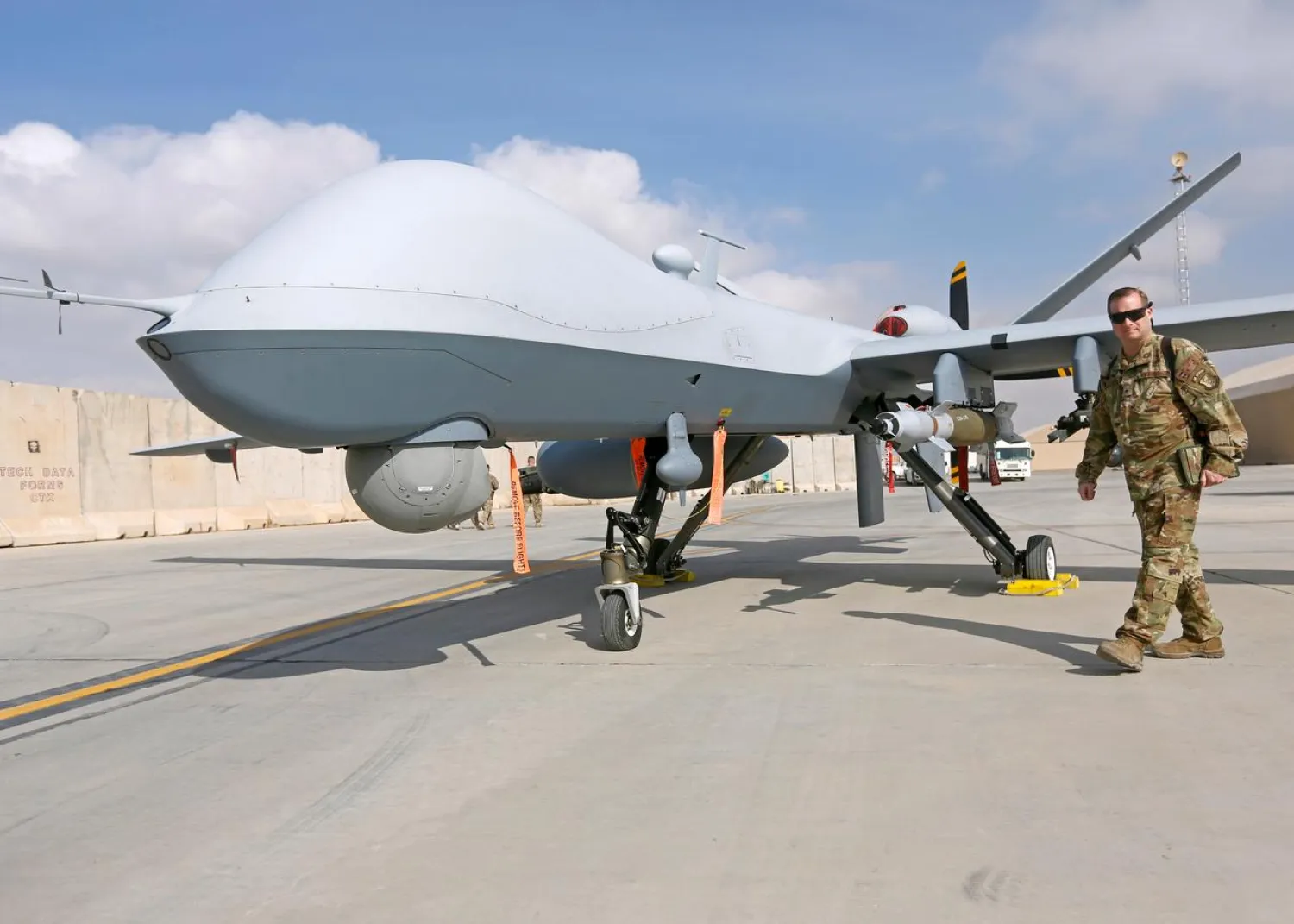 A US Air Force officer passes in front of a MQ-9 Reaper drone at the Kandahar air base, Afghanistan January 23, 2018. (Reuters)