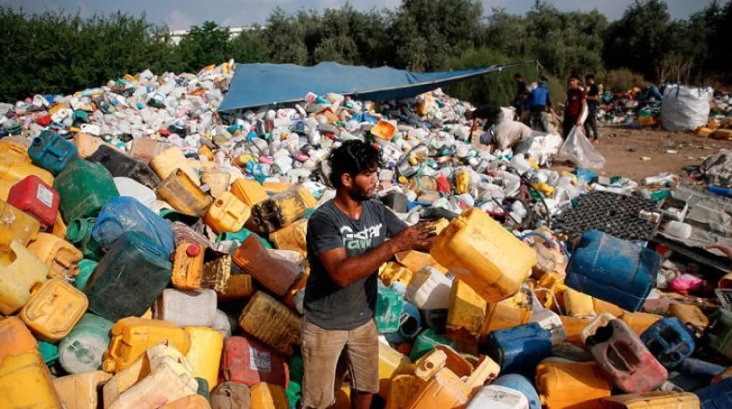 A young man collects plastic containers in a landfill in Gaza (AFP)
