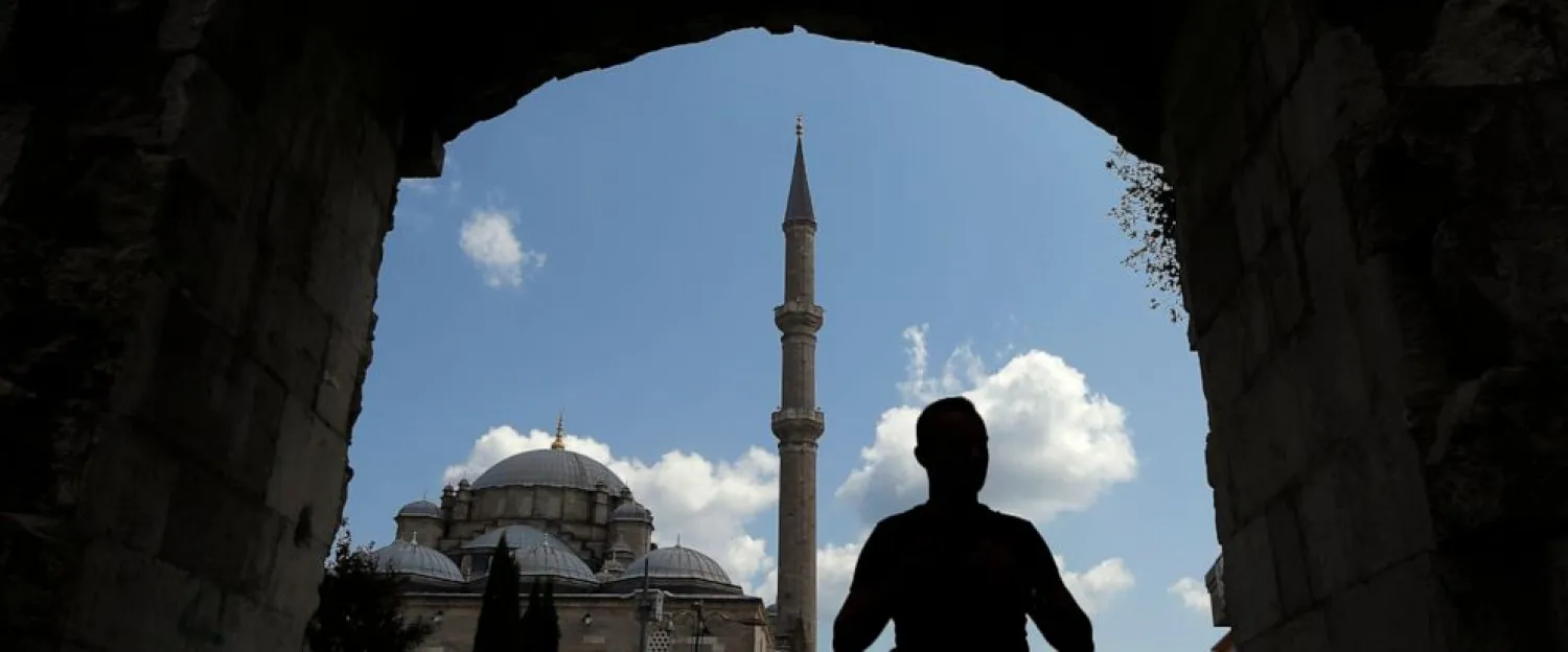 In this photo taken on Tuesday, Aug. 20, 2019, a man walks near Fatih mosque in Istanbul. Syrians say Turkey has been detaining and forcing some Syrian refugees to return back to their country the past month. (AP Photo/Lefteris Pitarakis)