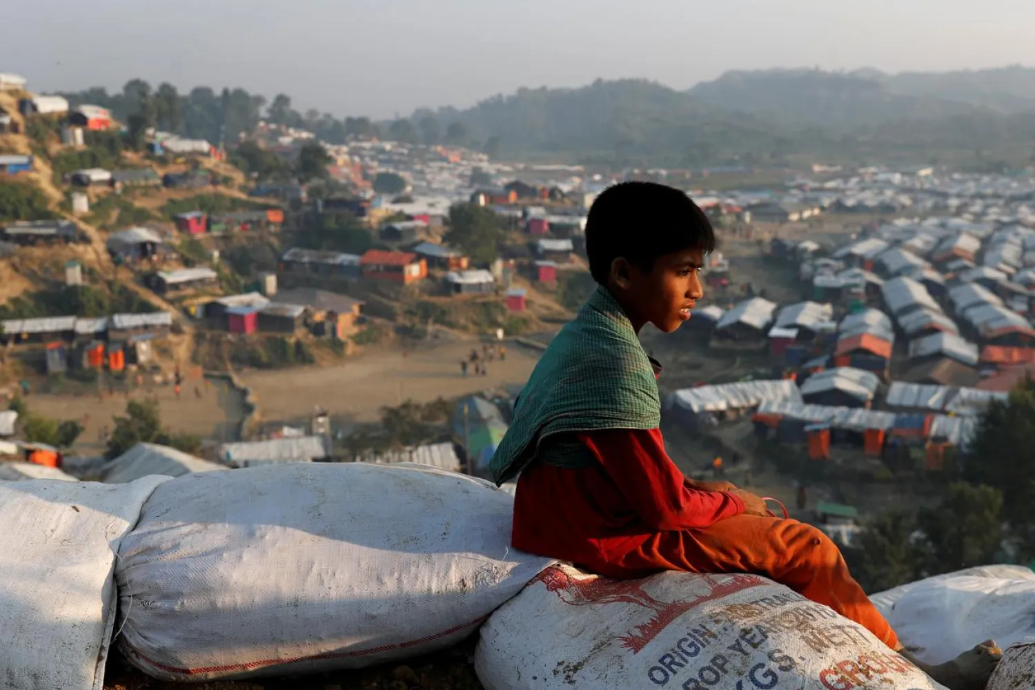 A Rohingya refugee child sits on a hill at Unchiparang refugee camp, near Cox's Bazar, Bangladesh January 11, 2018. (Reuters)