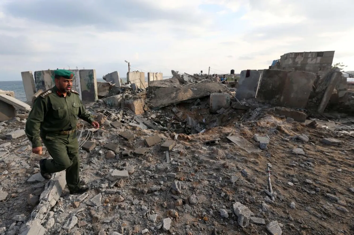 A member of Palestinian security forces loyal to Hamas inspects the scene of an Israeli air strike in the southern Gaza Strip October 17, 2018. REUTERS/Ibraheem Abu Mustafa