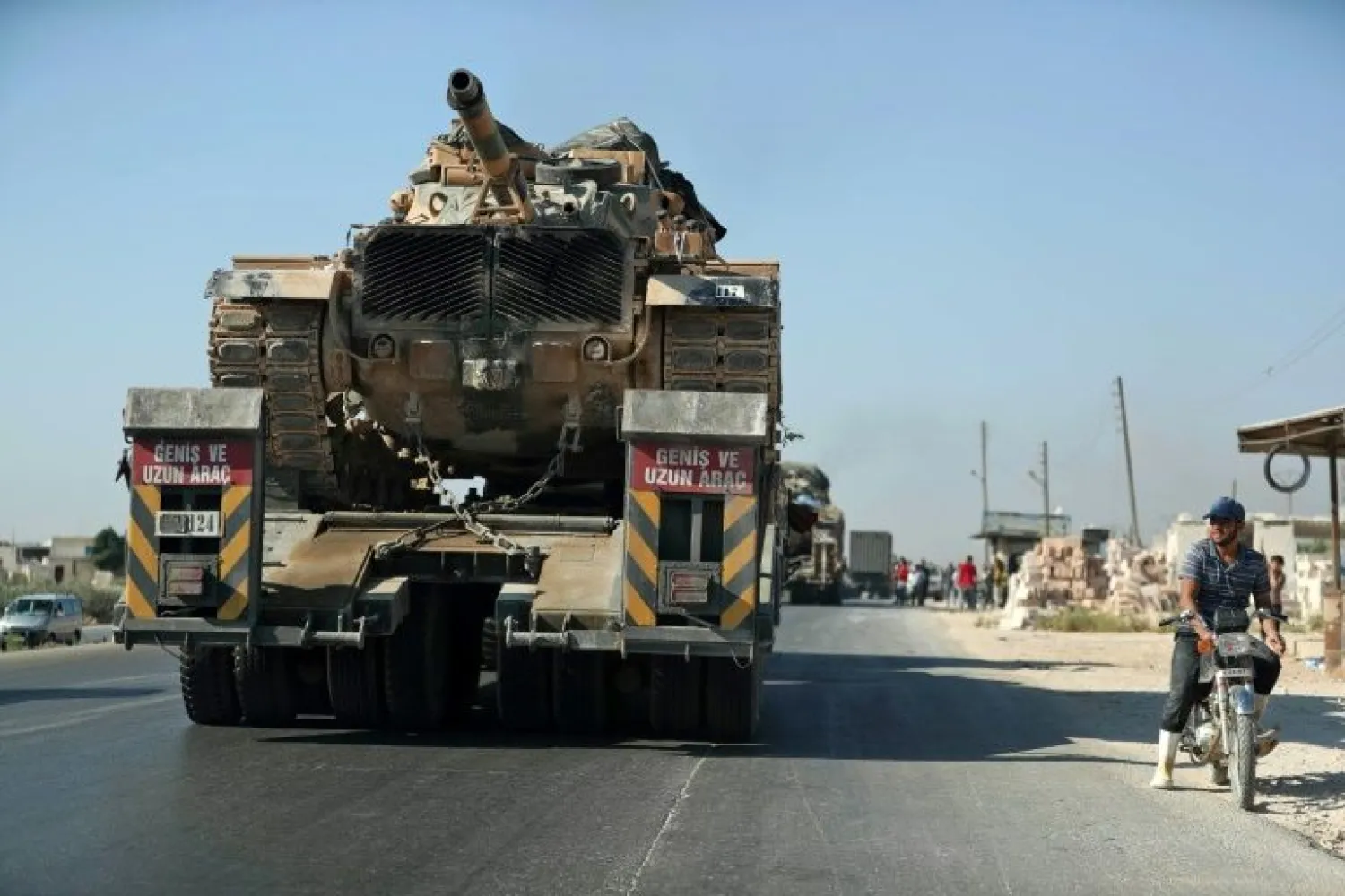 A convoy of Turkish military vehicles passes through the town of Saraqeb in Idlib province on August 19, 2019 (AFP/Omar HAJ KADOUR)