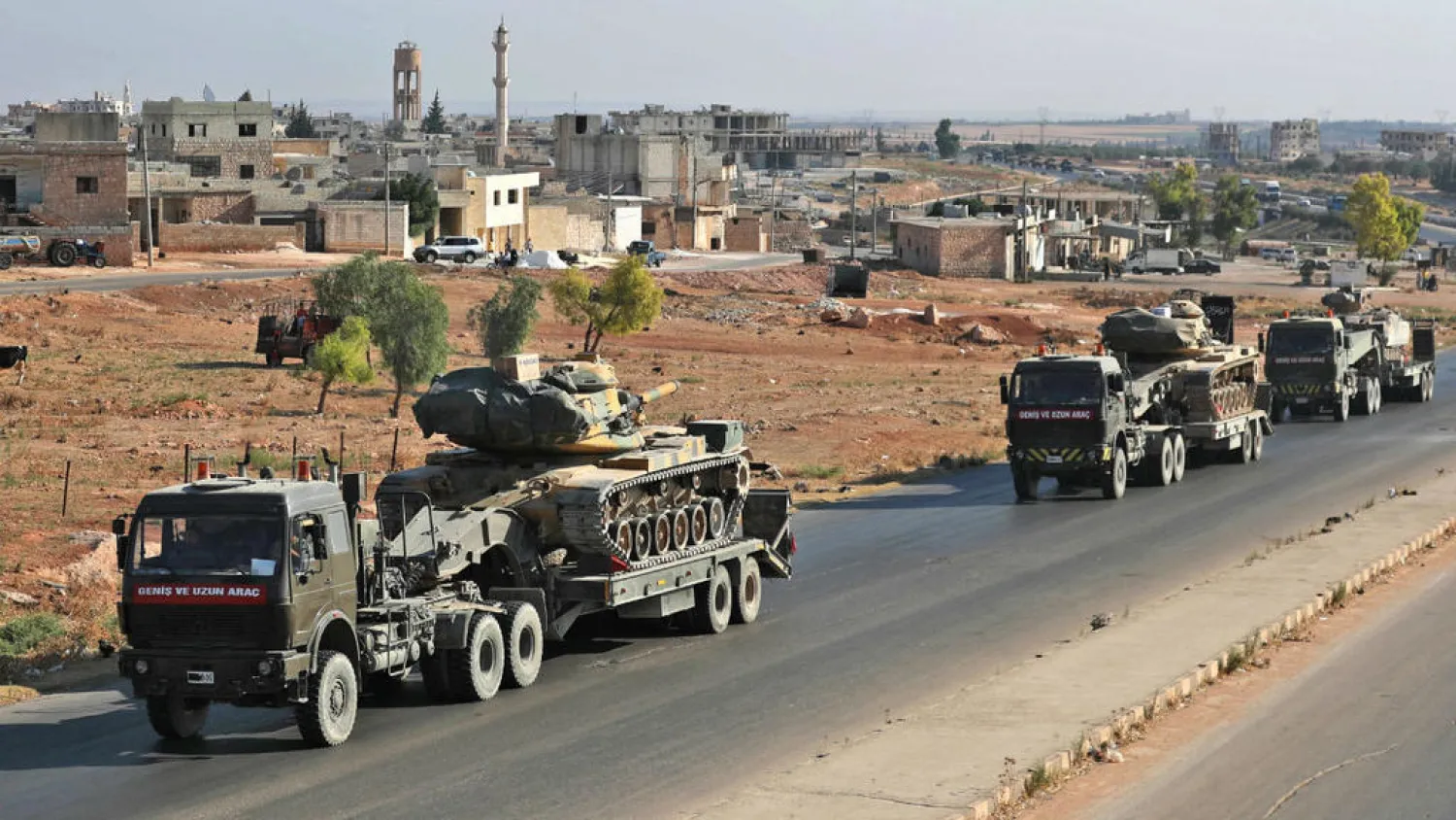 A convoy of Turkish military vehicles passes through the town of Saraqeb in Idlib on August 19, 2019. (AFP)