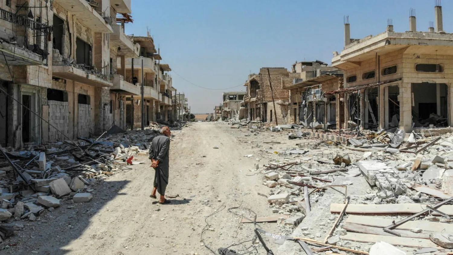 A Syrian man inspects the damage in the town of Khan Sheikhoun in the southern countryside of the northwestern Idlib province, August 3, 2019. (AFP)