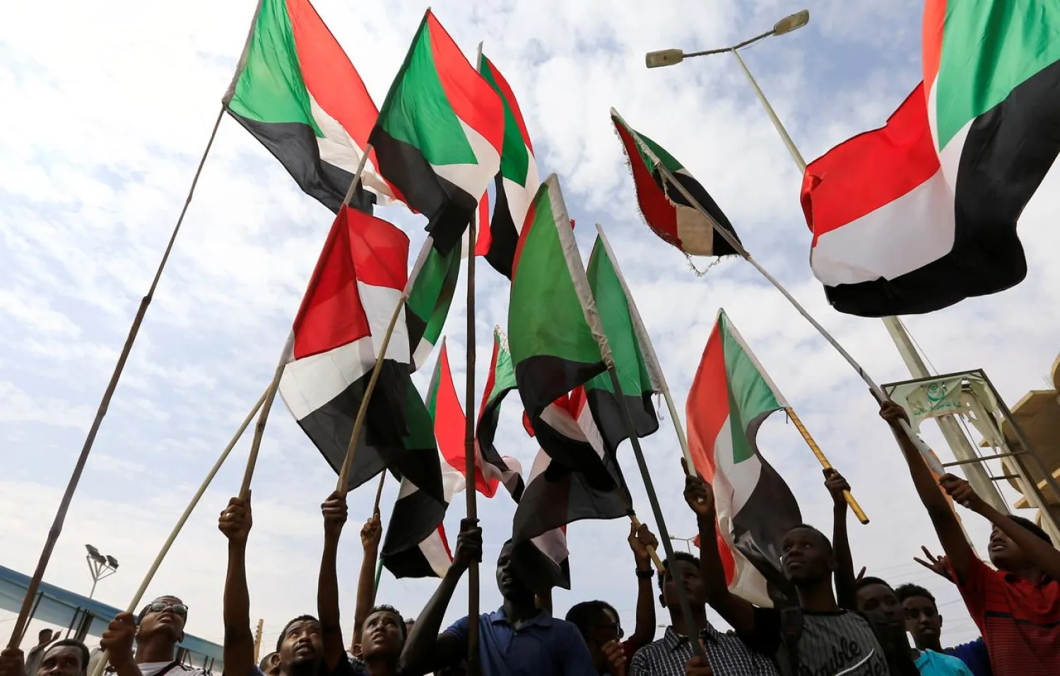 People wave national flags as they demonstrate in Khartoum, Sudan August 1, 2019. (Reuters)