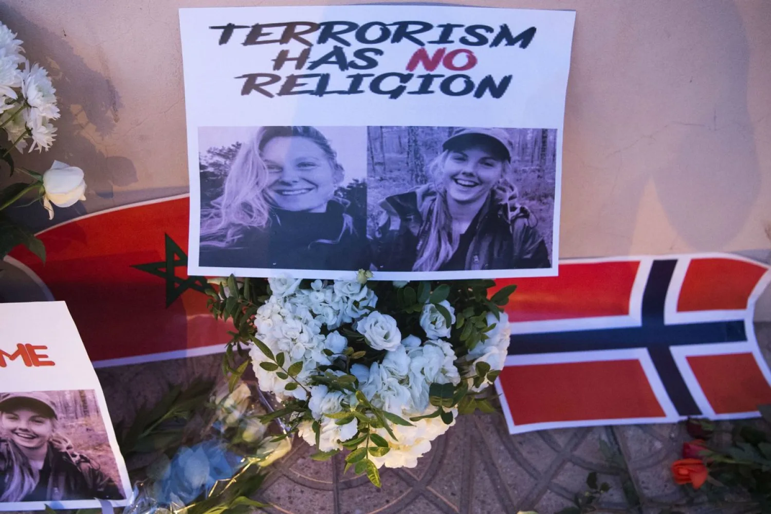 Flowers, pictures and flags in tribute to two young Scandinavian women killed while hiking in Morocco in December 2018 | AFP
