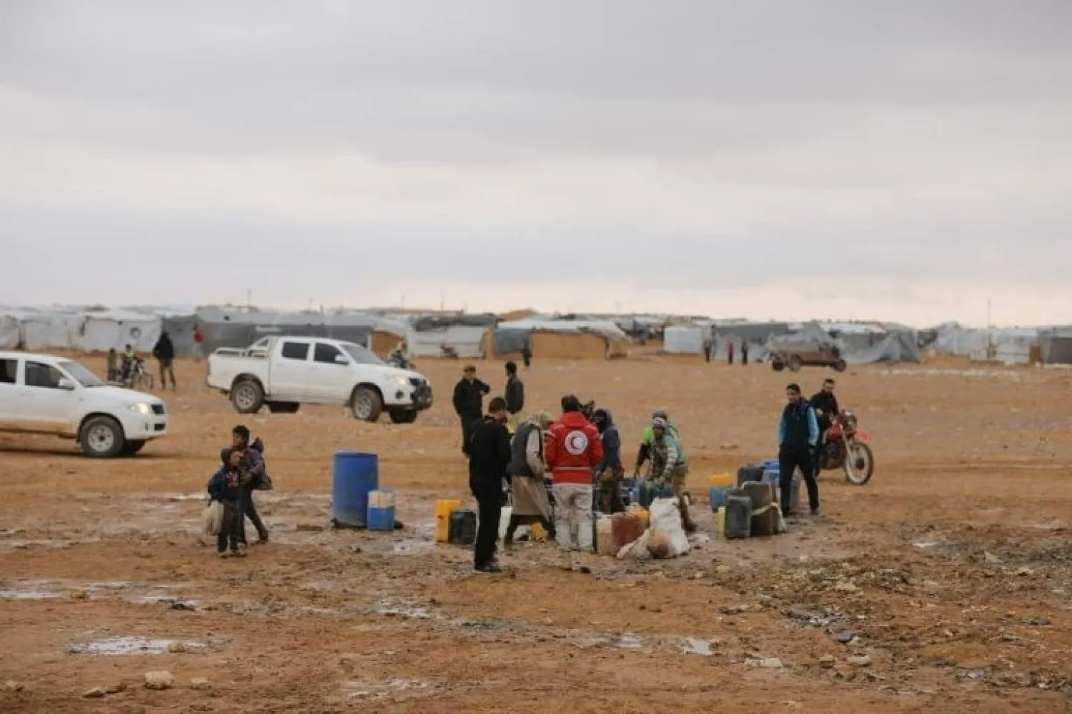 Syrian Arab Red Cross workers deliver humanitarian aids in the Rukban desert camp for displaced Syrians along the border with Jordan | AFP