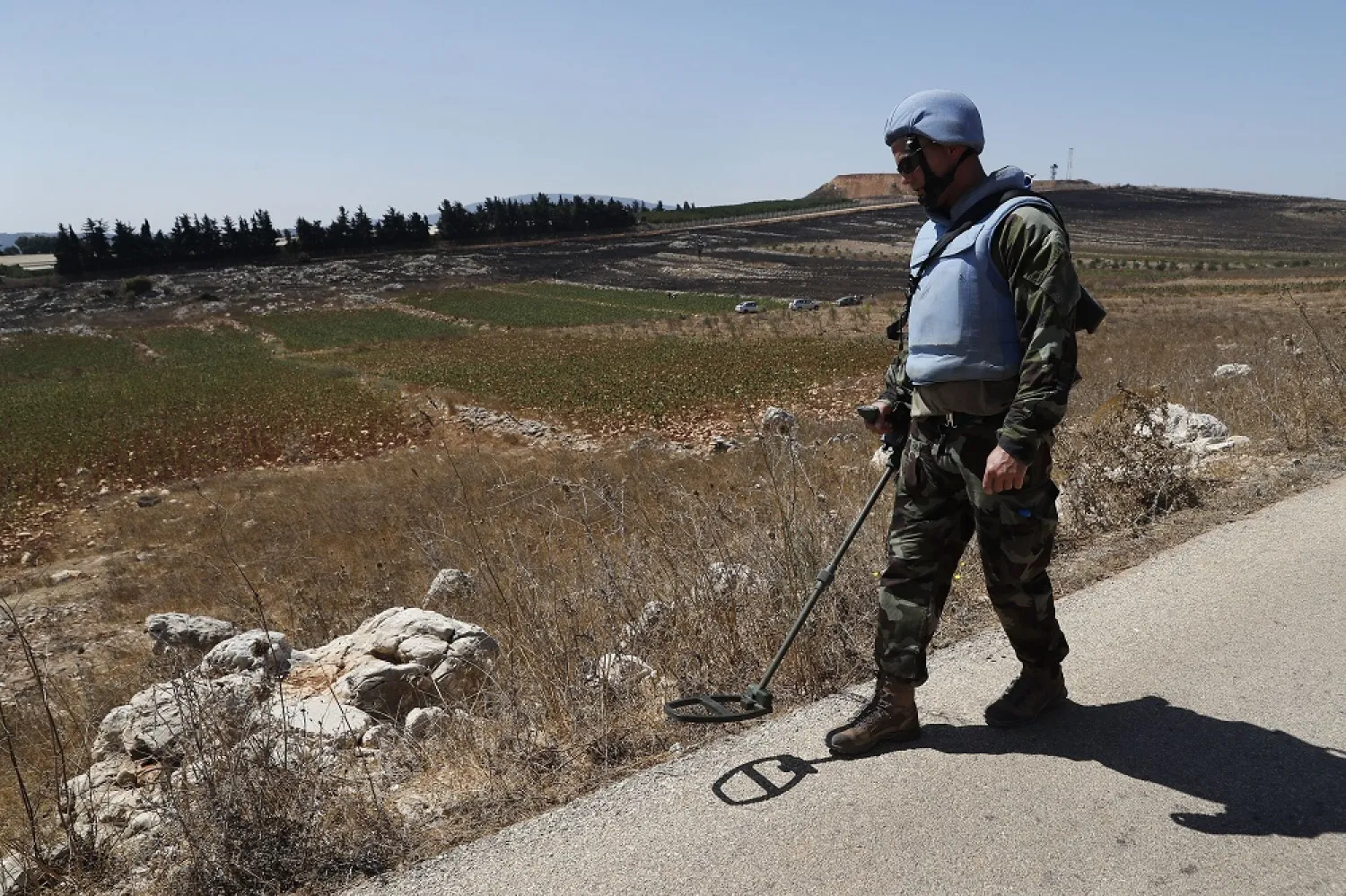 Irish UN peacekeepers use mine detectors as they patrol near the fields struck by Israeli army shells in the southern Lebanese-Israeli border village of Maroun al-Ras, Lebanon, September 2, 2019. (AP)