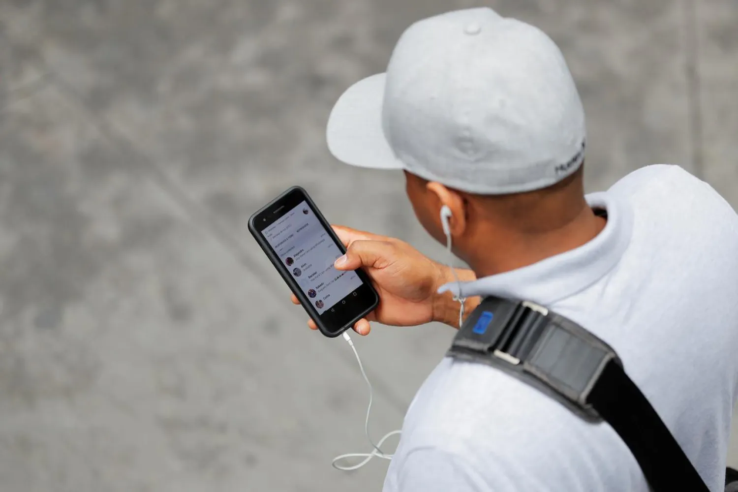 A man holds an Apple iPhone as he walks on a street in New York, US, August 1, 2018. (Reuters)