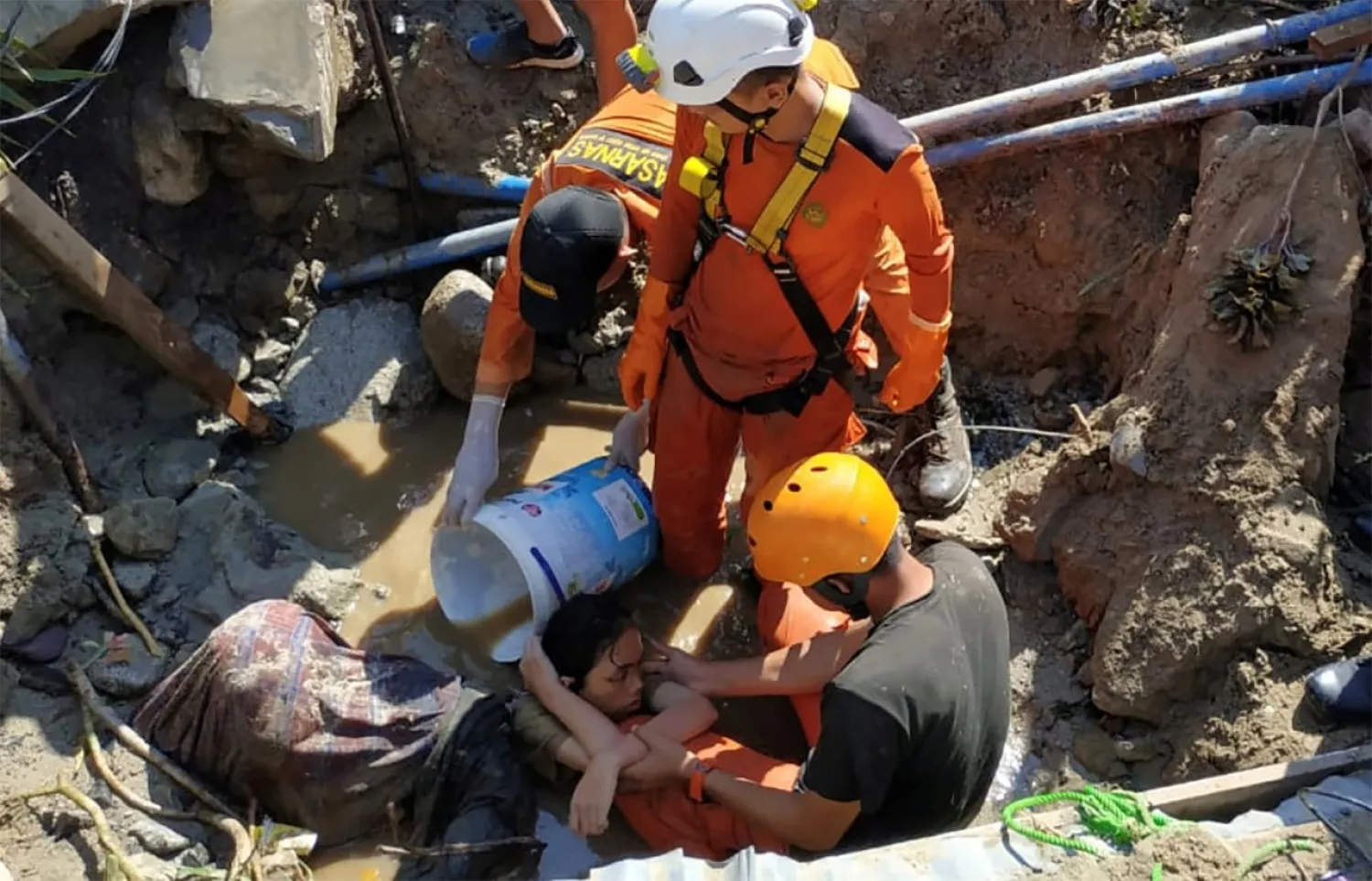 Search workers help rescue a person trapped in rubble following the earthquake and tsunami in Palu, Indonesia. Reuters file photo