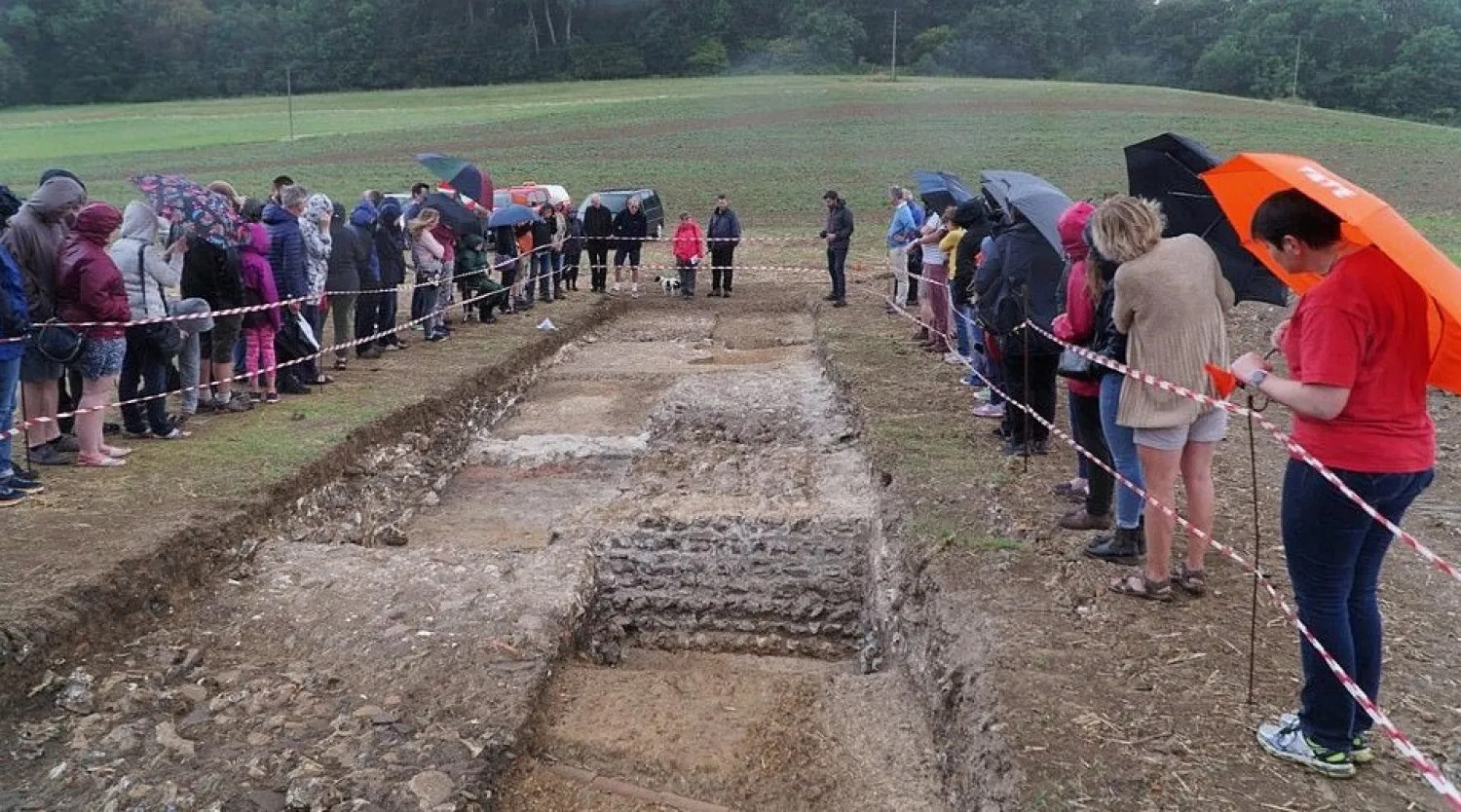 People gather in the rain as they admire the unearthing of the Roman mosaic. Credit: Boxford History Project
