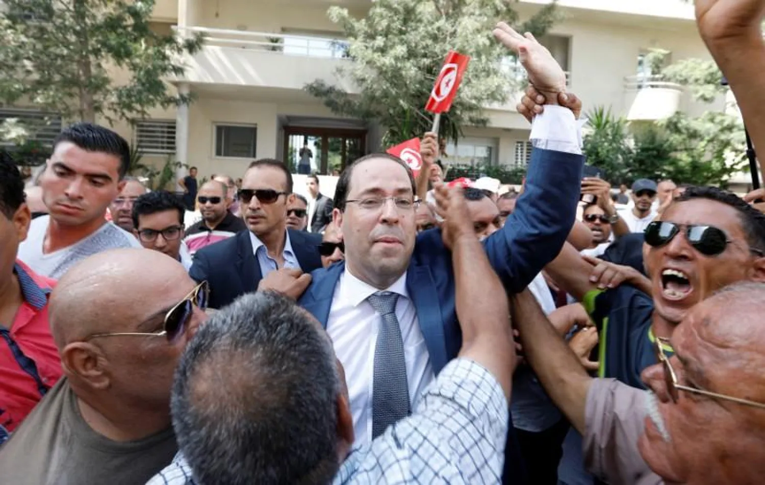 Tunisian Prime Minister Youssef Chahed reacts surrounded by supporters after submitting his candidacy for the presidential elections in Tunis, Tunisia August 9, 2019. REUTERS/Zoubeir Souissi