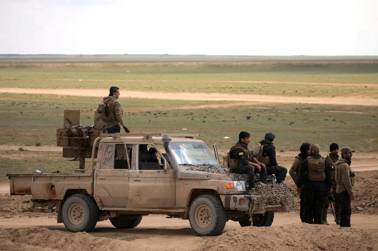 Members of Syrian Democratic Forces (SDF) stand together near Baghouz, Deir Ezzour province, Syria February 11, 2019. (Reuters)