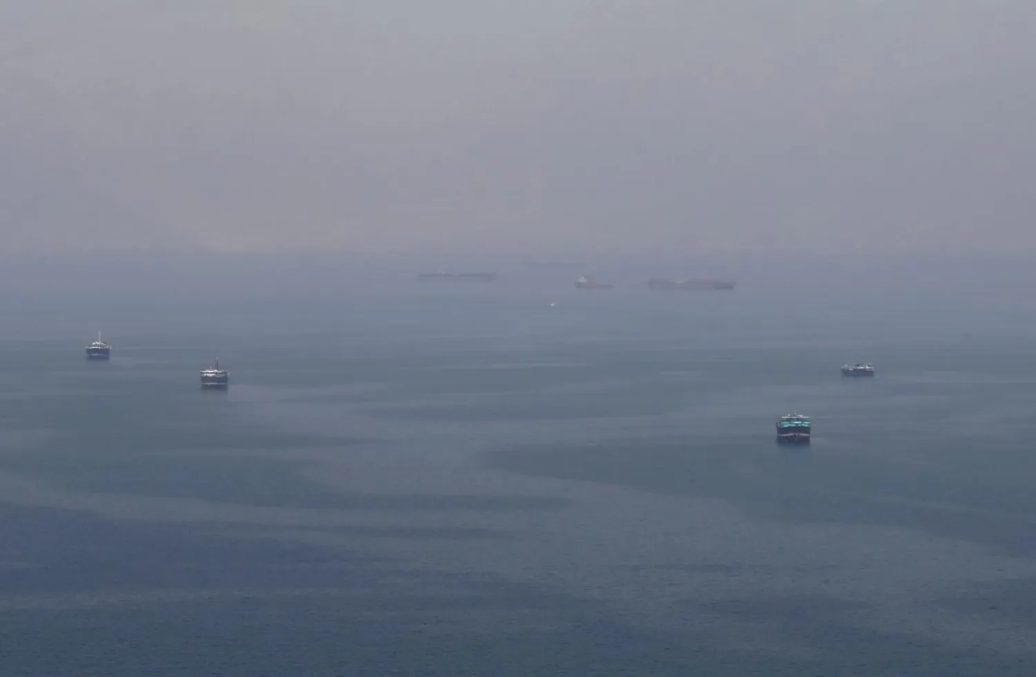FILE PHOTO: Traditional Omani boats known as dhows, and cargo ships are seen sailing towards the Strait of Hormuz, off the coast of Musandam province, Oman, July 21, 2018. REUTERS/Hamad I Mohammed/File Photo
