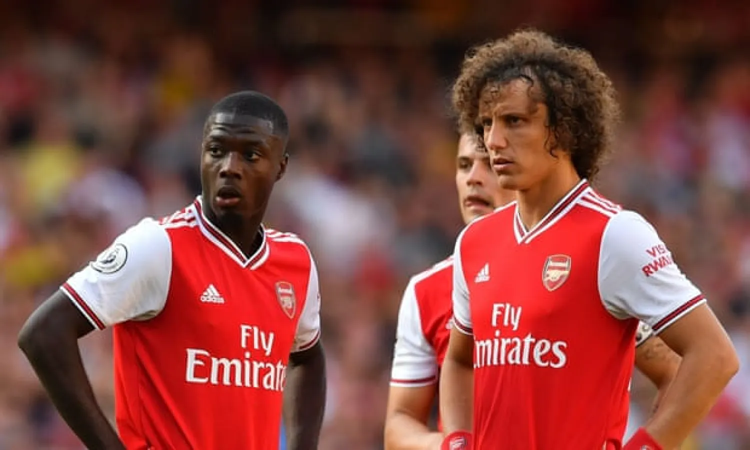  The arrival of Nicolas Pépé (left) completes a mouthwatering front three for Arsenal, but having David Luiz (right) at the back is creating a new set of problems. Photograph: Ben Stansall/AFP/Getty Images
