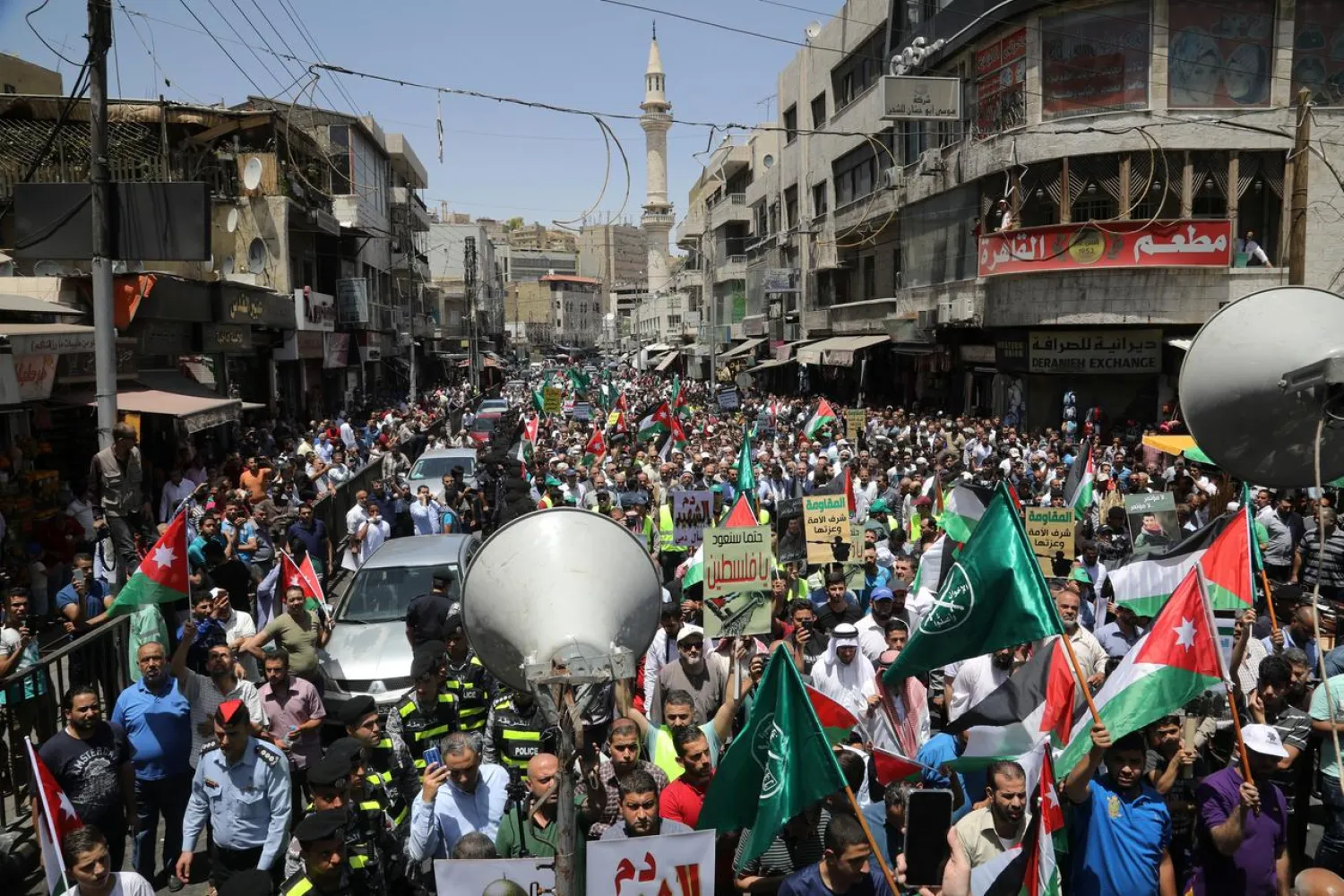 Jordanian protesters hold Jordanian national flags as they chant slogans during a protest against U.S. President Donald Trump's "Deal of the Century", after the Friday prayer in Amman, Jordan, June 21, 2019. REUTERS/Muhammad Hamed
