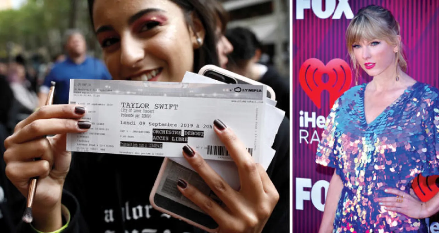 المغنية تايلور سويفت  -  إحدى مشجعات تايلور سويفت تحمل تذكرتها قبل حفلها الموسيقي في باريس (رويترز)