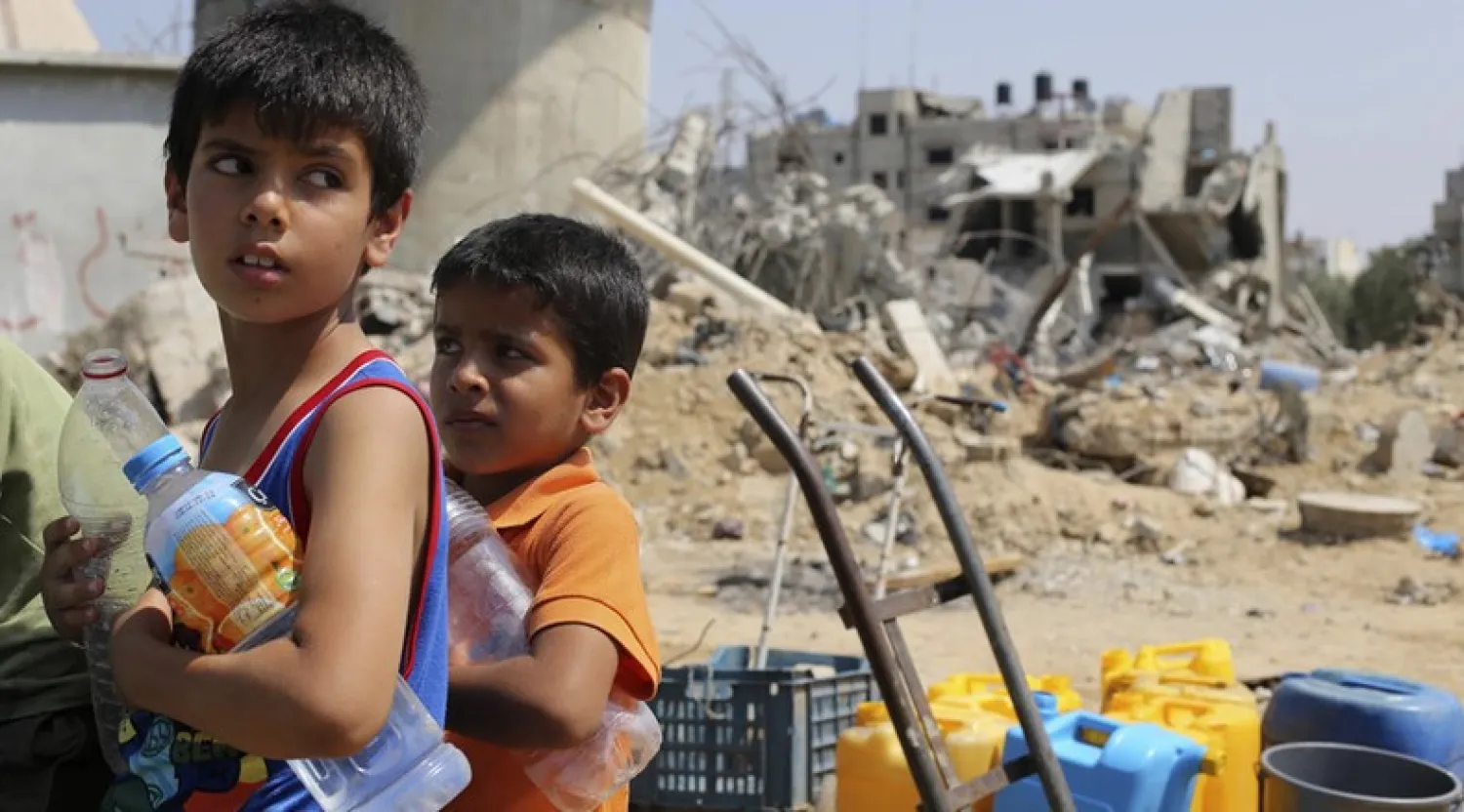 Palestinian children wait to collect water during a five-day truce in Khan Younis in the southern Gaza Strip. Ibraheem Abu Mustafa|Reuters