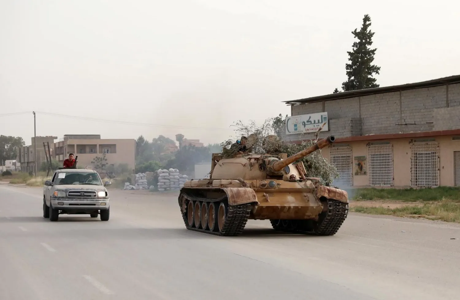 Members of Libyan internationally recognized government forces ride a tank taken over from Eastern forces, south western Tripoli, Libya (Reuters)