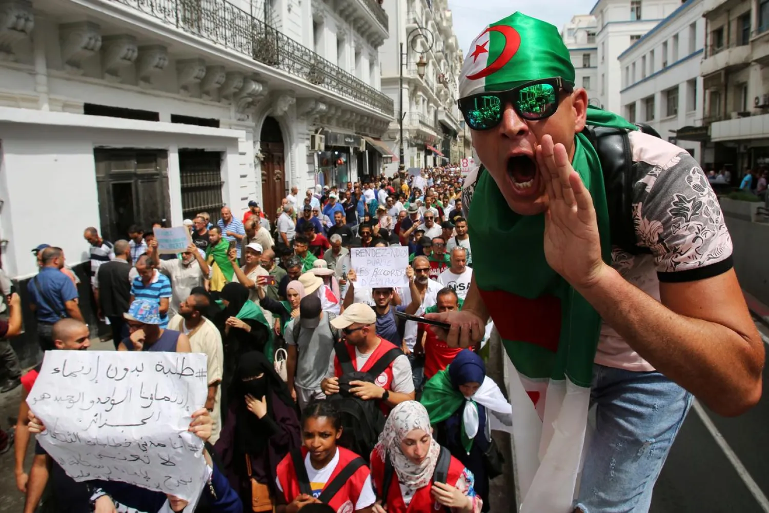 A demonstrator shouts slogans during a protest demanding social and economic reforms as well as the departure of the country's ruling elite in Algiers, Algeria August 27, 2019. (Reuters)