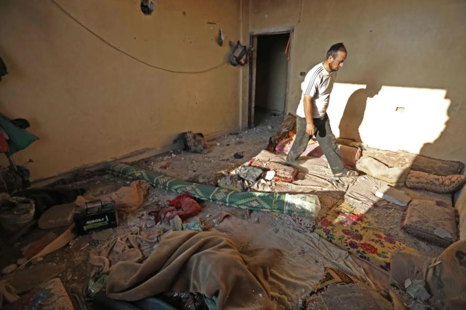 A reported Russian airstrike on Wednesday hit a building that was hosting displaced Syrians in the village of al-Daher | AFP