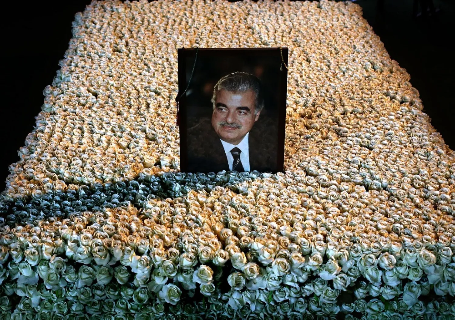 A portrait of slain Lebanese Prime Minister Rafik Hariri sits on his grave which is covered by flowers in downtown Beirut, Lebanon, Wednesday, Jan. 15, 2014. (AP)