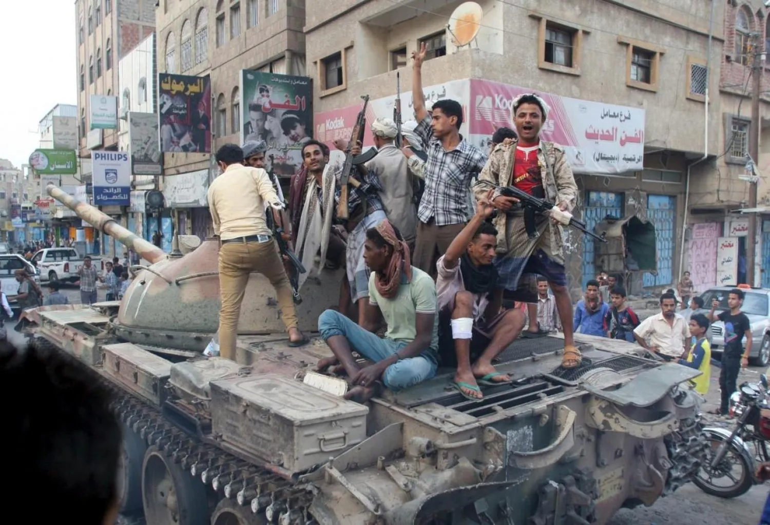 Militants loyal to Yemen's exiled government ride atop a tank they seized from Houthi militiamen in the country's central city of Taiz August 17, 2015. REUTERS/Stringer