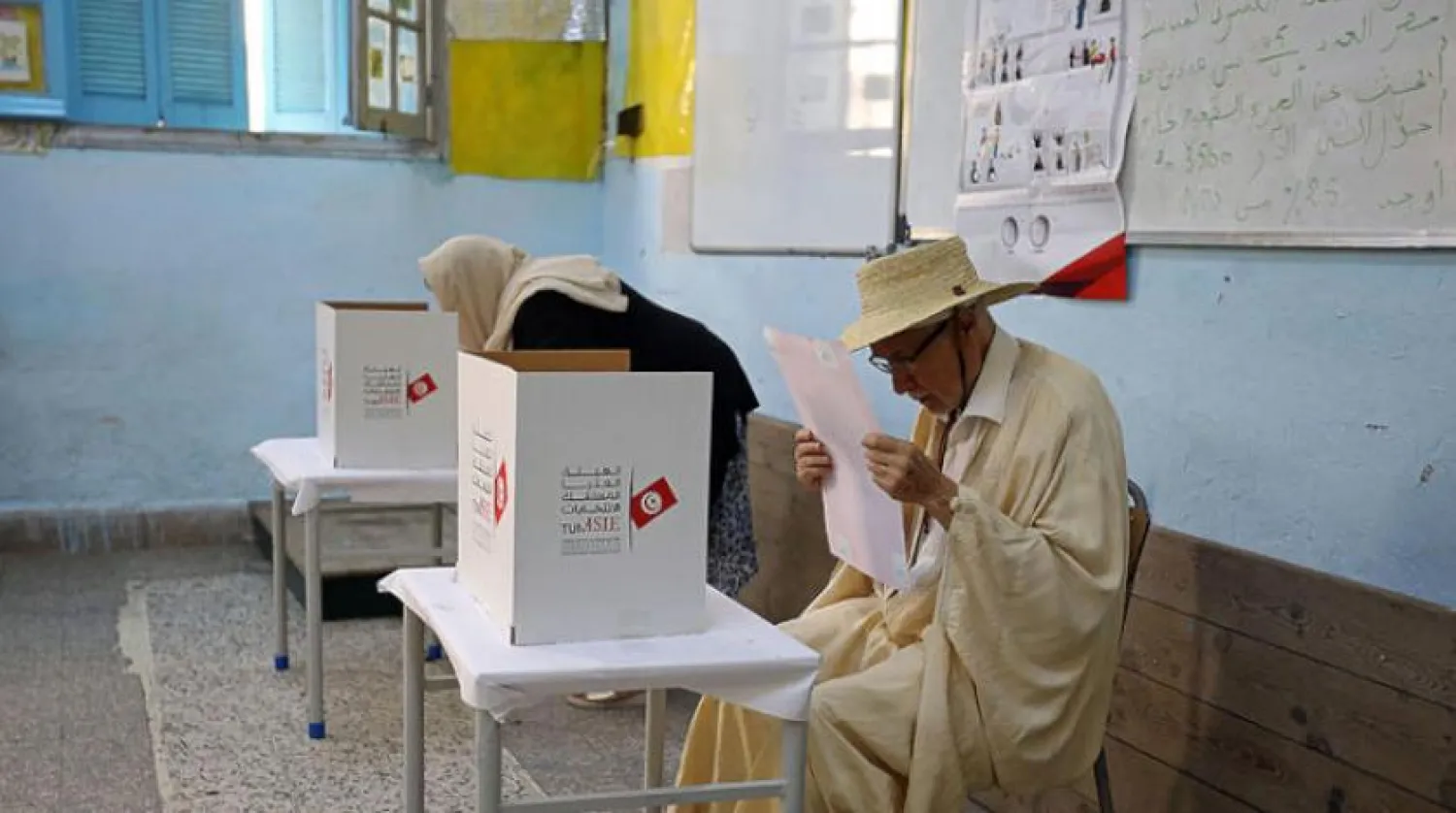A man reads his ballot paper at a polling station during presidential election in Tunis, Tunisia, September 15, 2019. REUTERS/Muhammad Hamed 