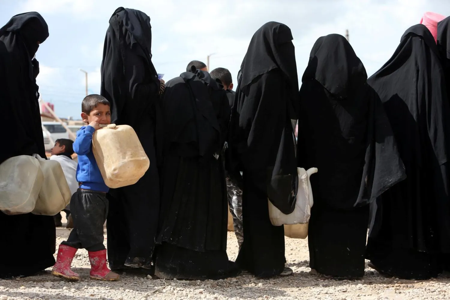 Women stand in line to get fuel at al-Hol displacement camp in al-Hasaka governorate, Syria April 1, 2019. (Reuters)