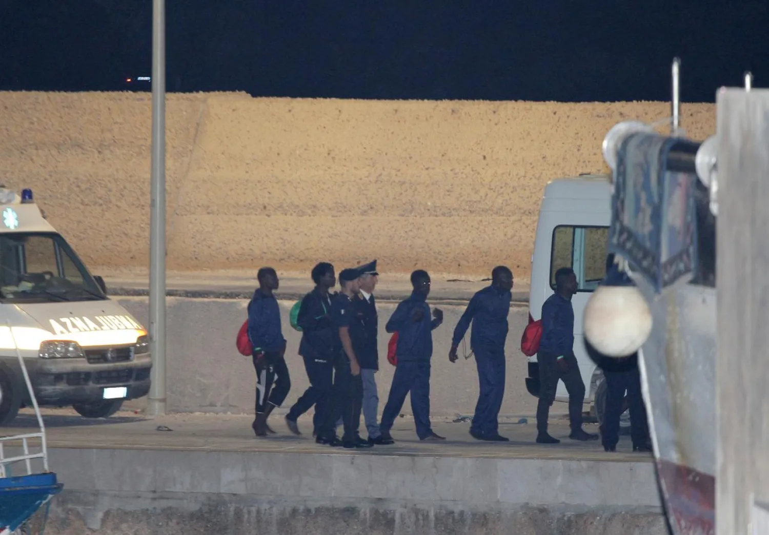 Migrants board a vehicle at the port in Lampedusa after the Italian government allowed the disembarkation of 82 migrants on board the rescue ship Ocean Viking, Italy, September 14, 2019. REUTERS/Mauro Buccarello